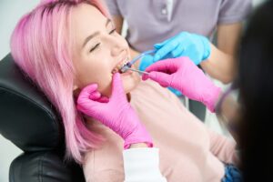 Young woman at an appointment receiving orthodontic care in Naples